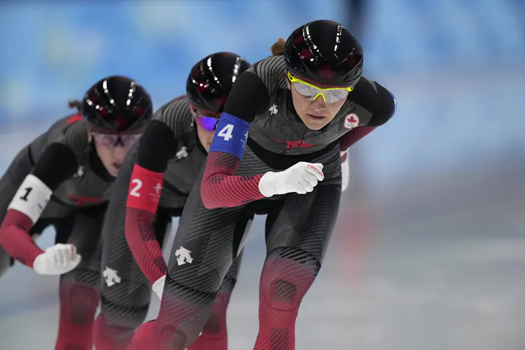 Three women speedskating in a line