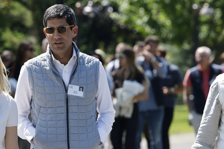 Kevin Warsh walking outside after a conference in 2024.