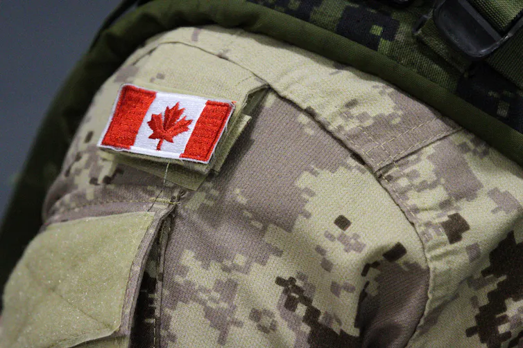 a small canadian flag on the shoulder of a soldier's uniform