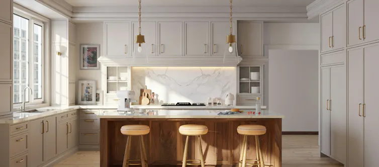 A modern kitchen with benches at an island.