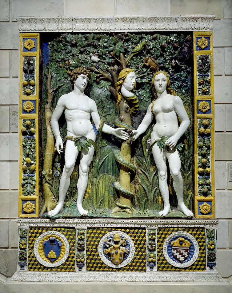 A naked man and woman, touching hands, with fig leaves covering their genitals