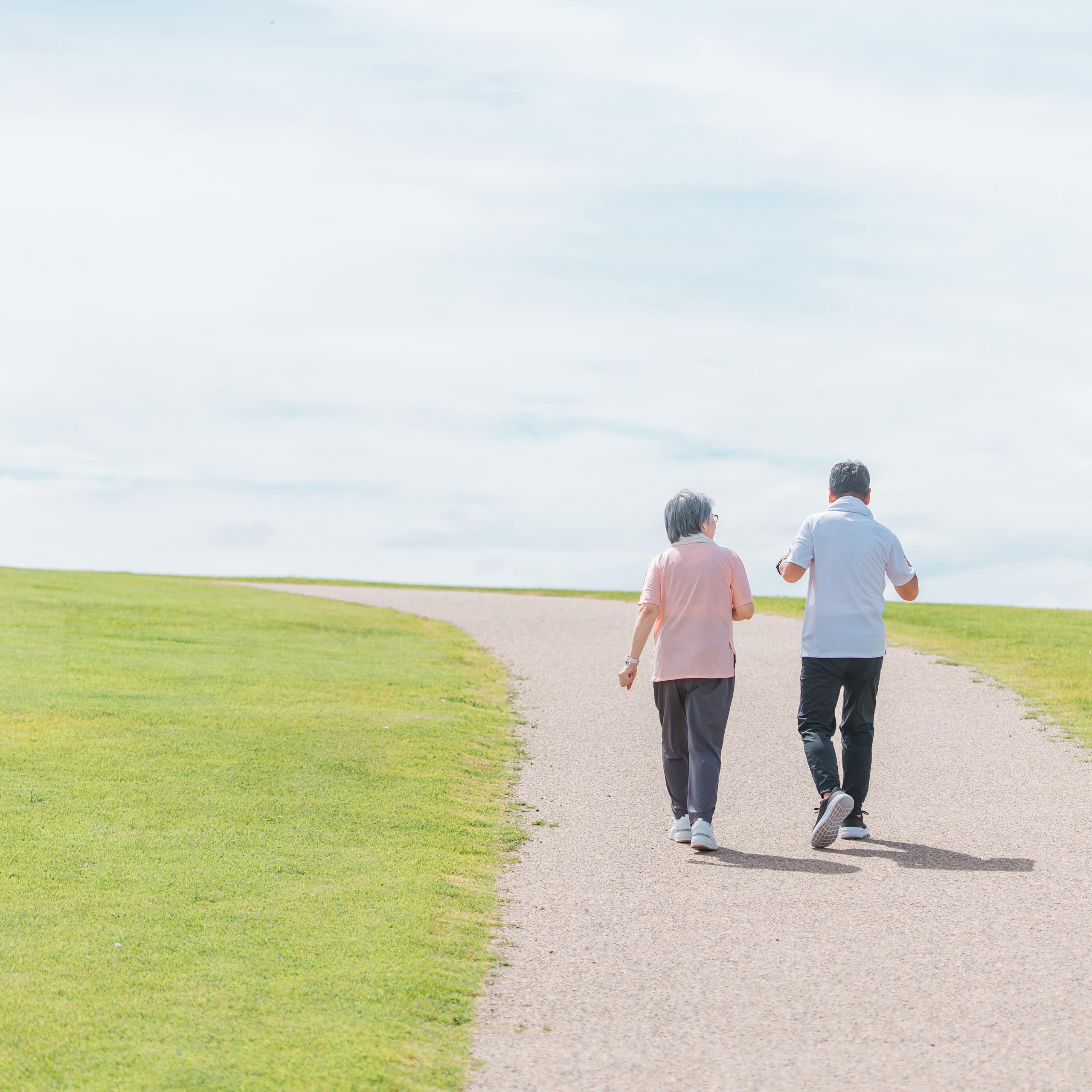 An elderly couple going for a walk.