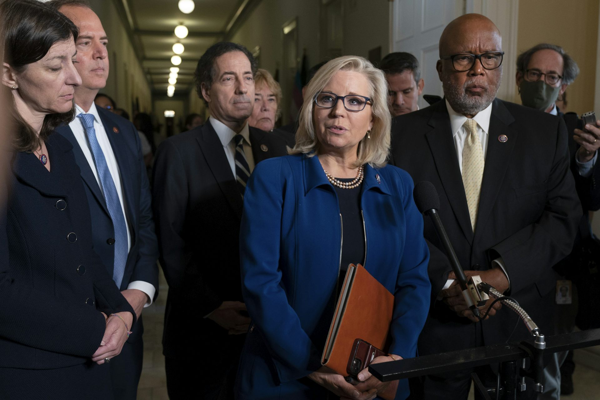 Liz Cheney, a former House Republican, speaks at a microphone alongside other Jan. 6 investigators.