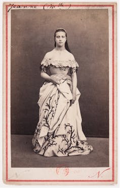 Black and white portrait of a woman in a shoulderless gown