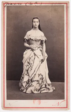 Black and white portrait of a woman in a shoulderless gown
