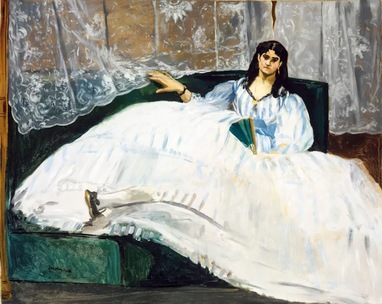 Painting of a woman in a voluminous white dress reclining with a fan in hand