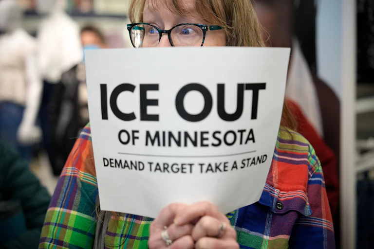 A protester holds a sign.