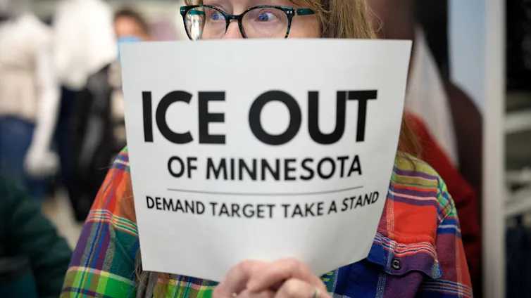 A protester holds a sign.