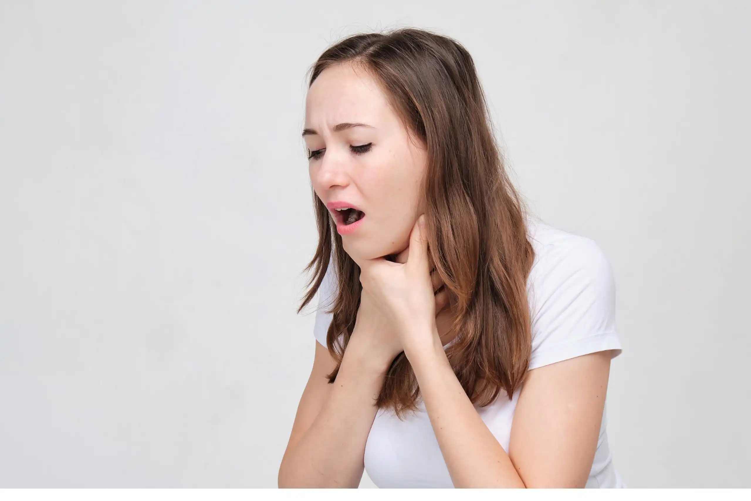 A young woman in a white T-shirt with choking