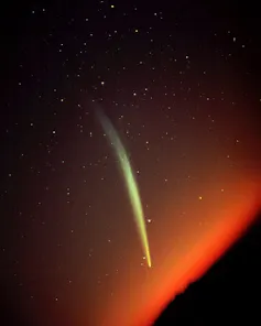 A greenish vertical streak in an orange sky.