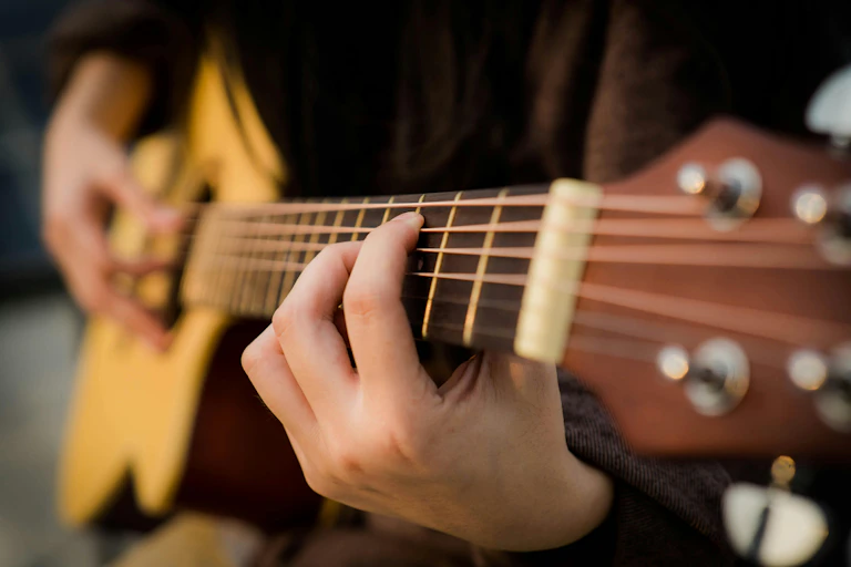 Person playing acoustic guitar