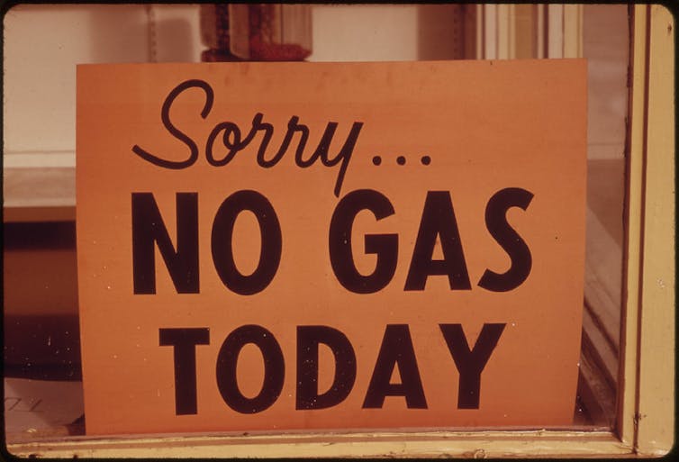 sign saying no gas today in shop window, historic image from 1970s America.