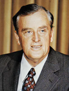 A grey-haired man in a suit
