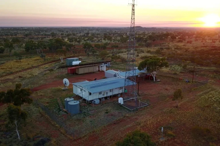 Aerial photo of some buildings in a flat, scrubby landscape
