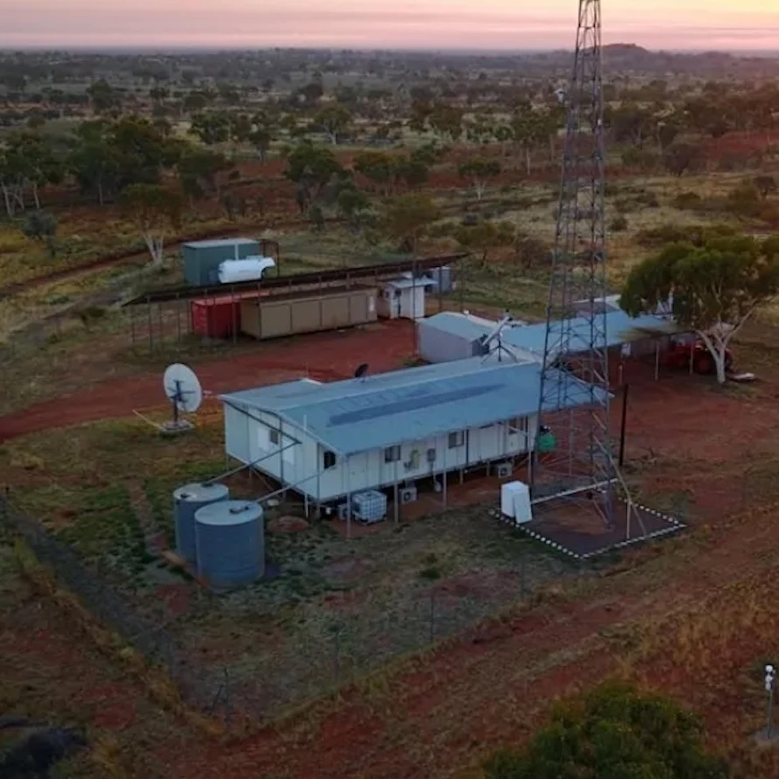 Aerial photo of some buildings in a flat, scrubby landscape