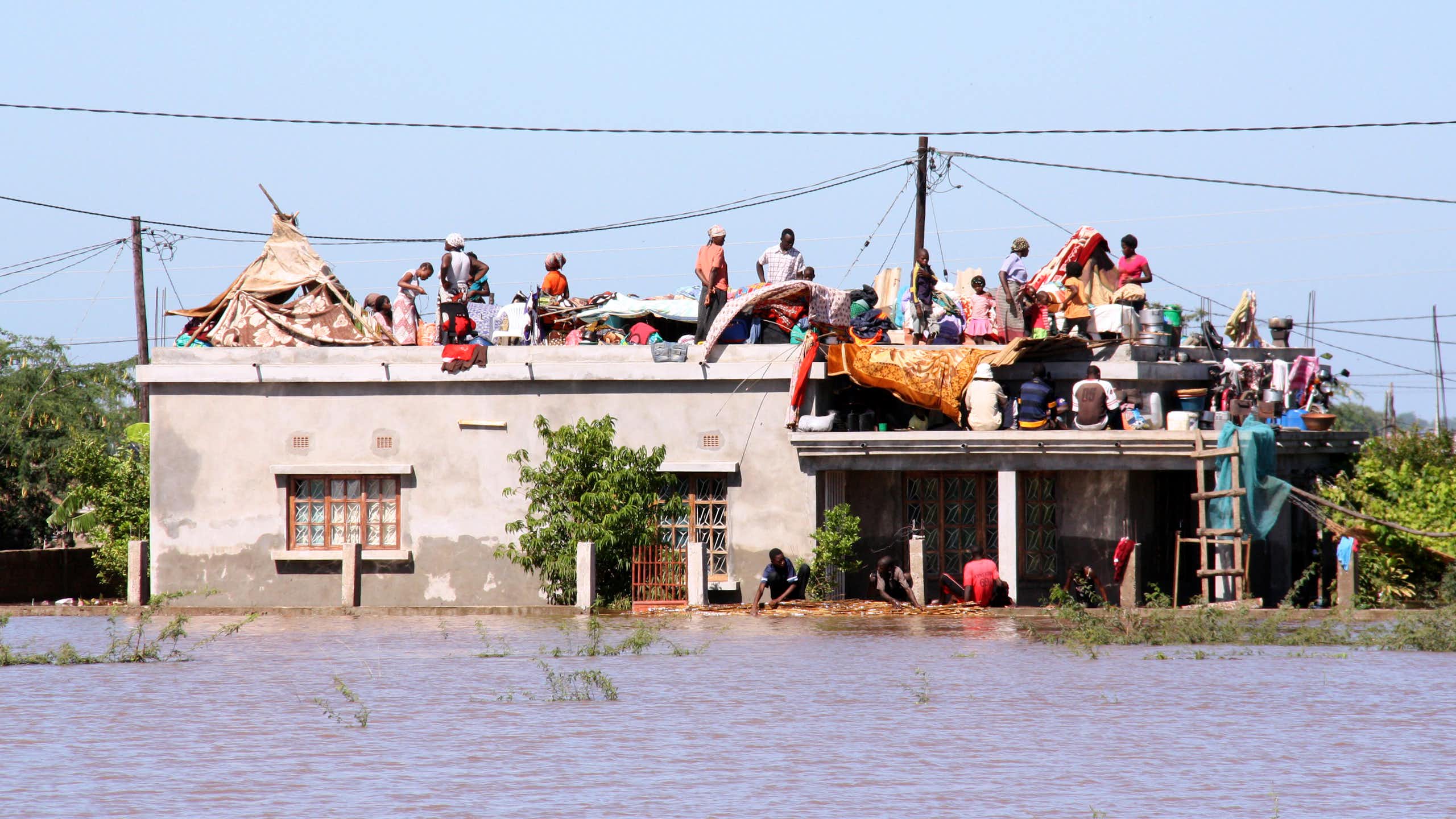 People on the roof of a building that's surrounded by water
