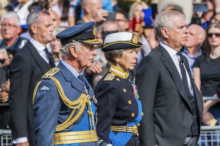 scam detection King Charles, Princess Anne and then Prince Andrew at the late queen's funeral procession
