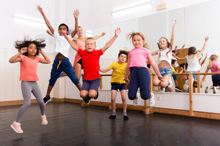 Children jumping in dance studio