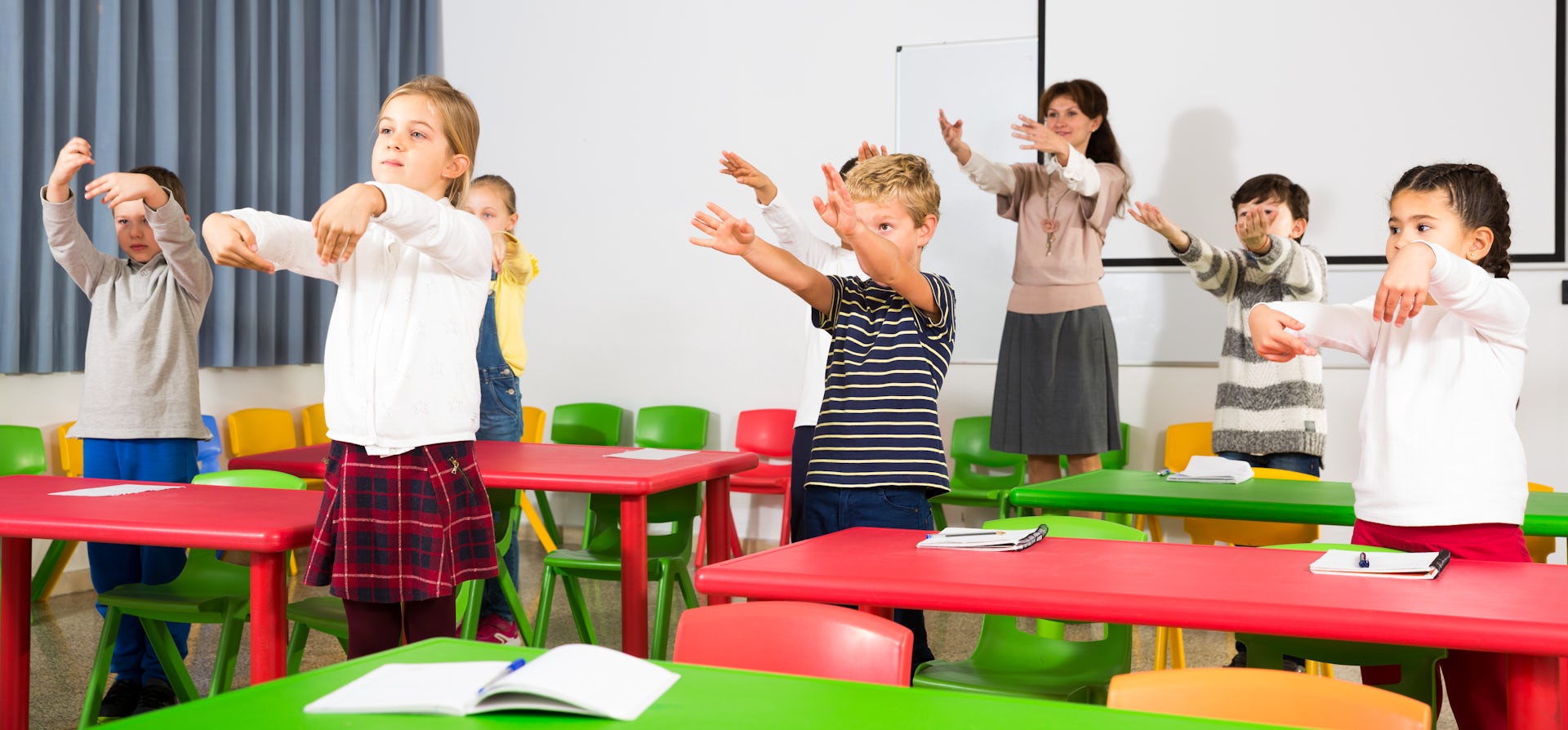 Children doing stretching exercises in class