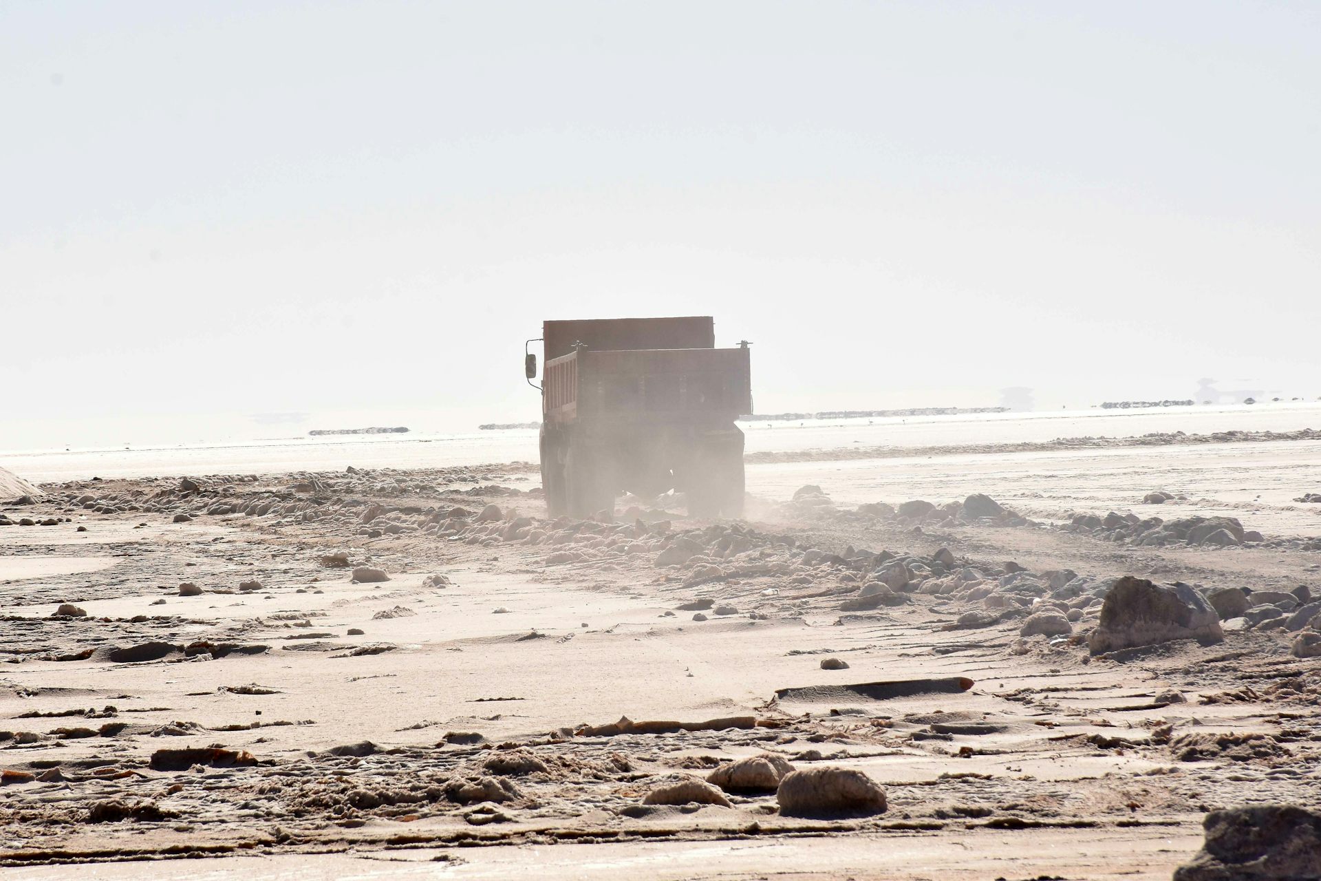 A truck drives through a salt flat in Bolivia.