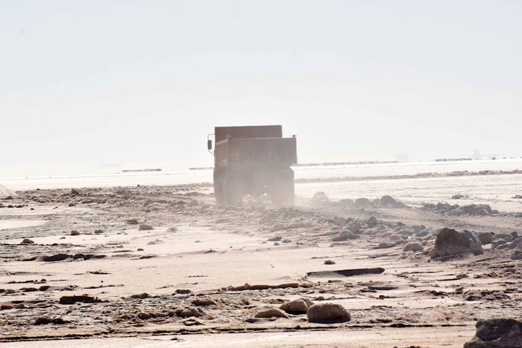 A truck drives through a salt flat in Bolivia.