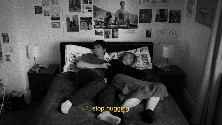 A couple hugging in bed