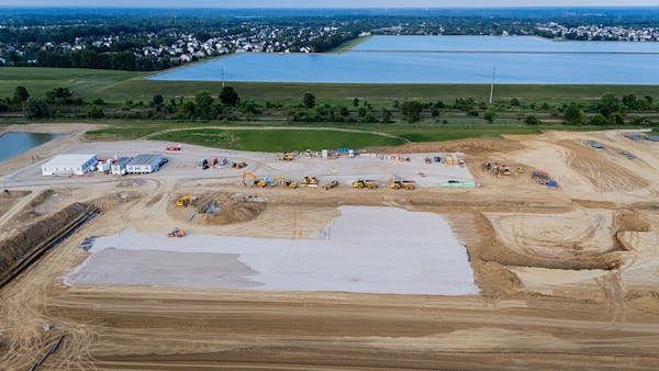 Construction vehicles and equipment surround AI data center.