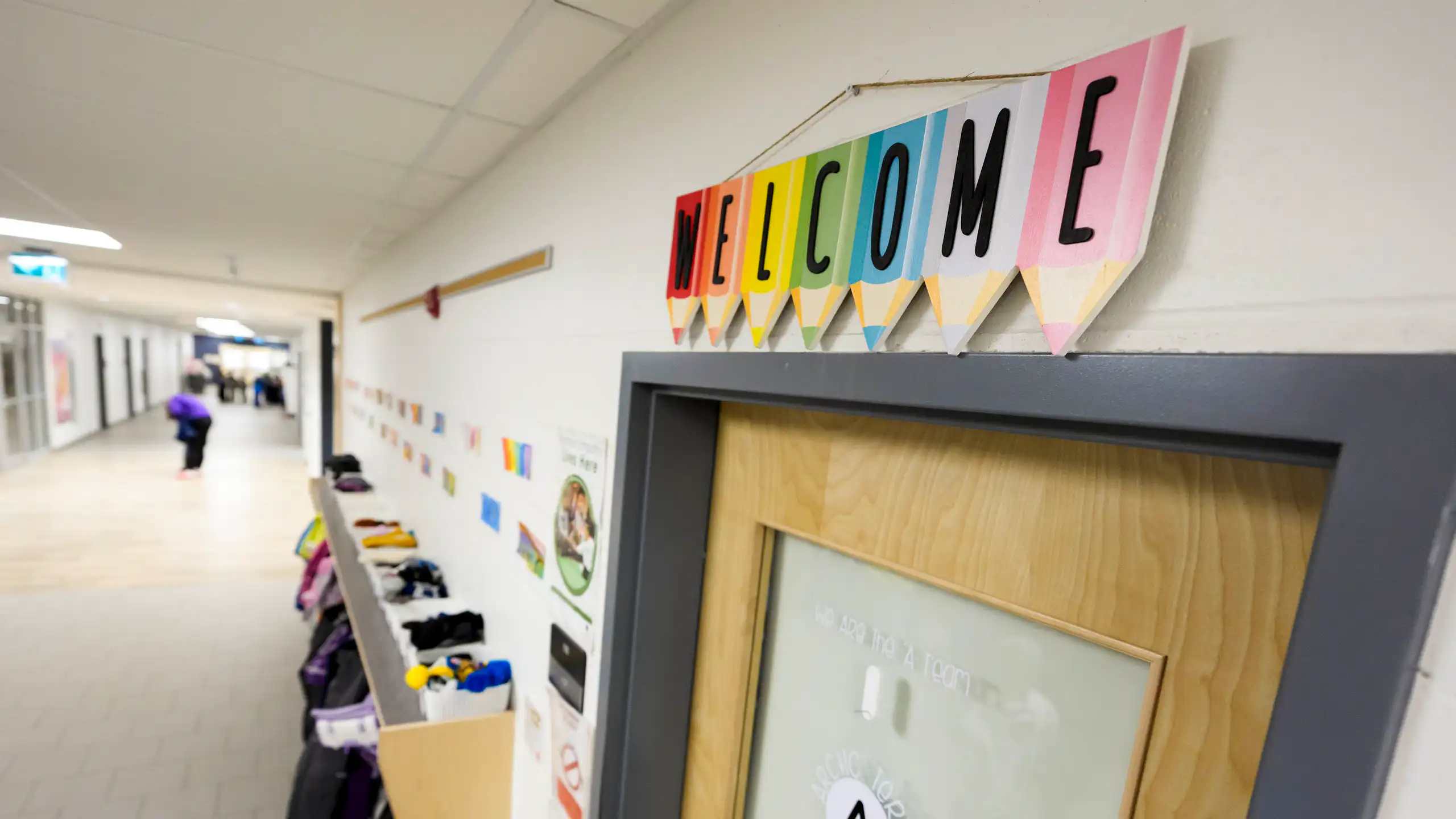 A colourful 'welcome' sign over a classroom door.