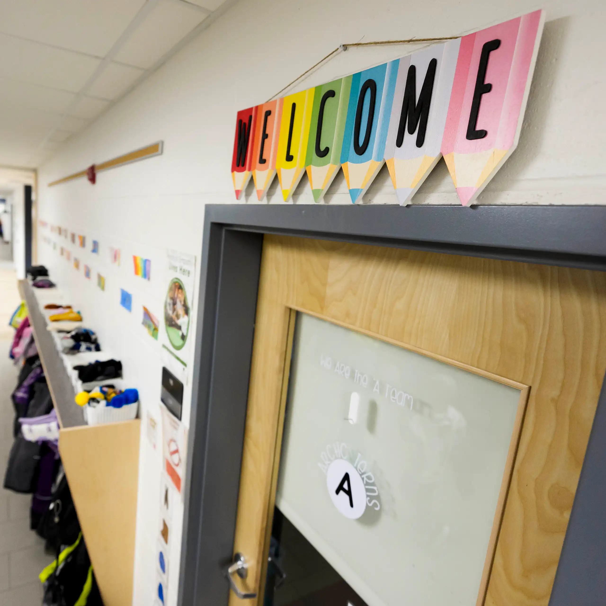A colourful 'welcome' sign over a classroom door.