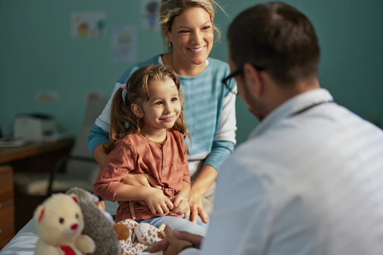 Mother and young daughter seeing male GP