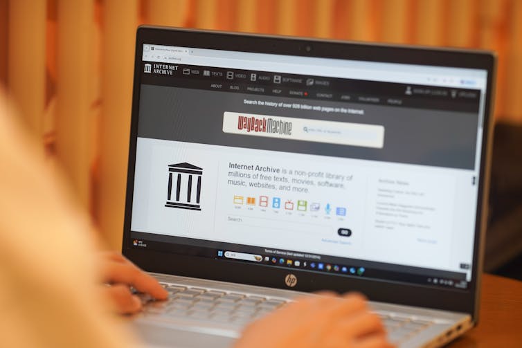 A person browses the Internet Archive on a laptop