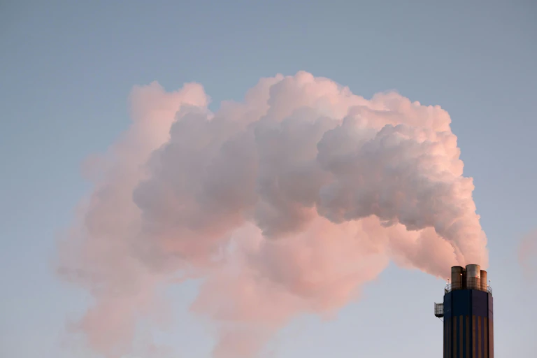 smoke from factory going into sky.