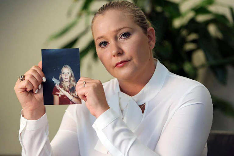 Giuffre holds a photo of herself as a teen