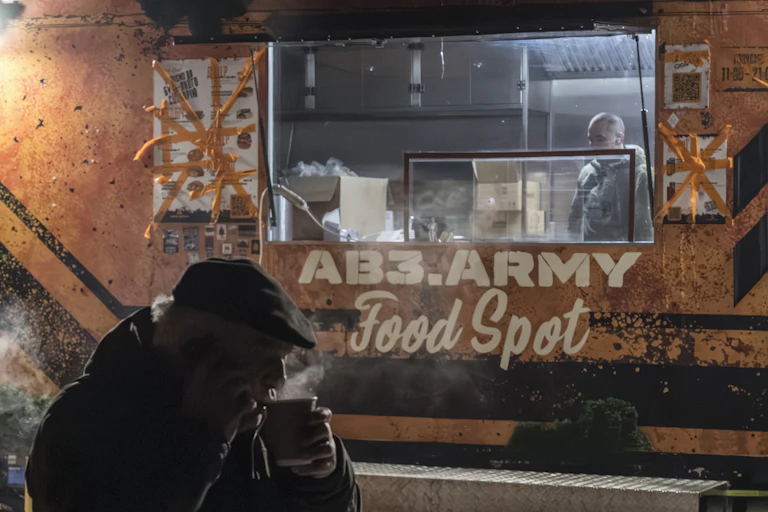 A man sips a hot drink outside a food truck ion Kyiv, Ukraine, February 4 2026.