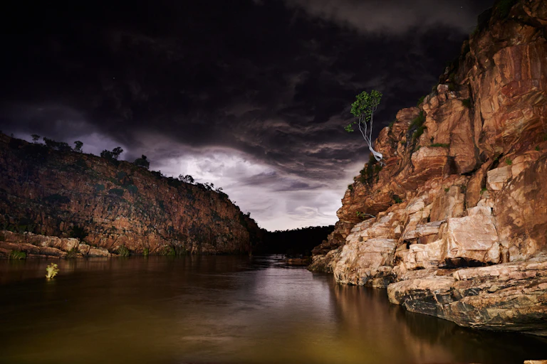 Fitzroy River under heavy clouds, remote waterway with high banks