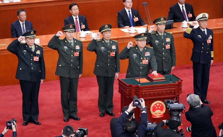 A group of top Chinese military officers swearing an oath.
