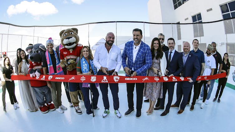 Ribbon cutting ceremony with mascots present. Local officials get to participate in events such as ribbon cuttings, celebrating projects they may have helped make happen.