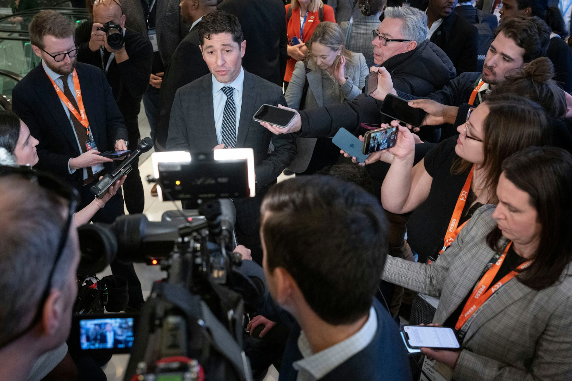A large group of reporters surround Minneapolis Mayor Jacob Frey.