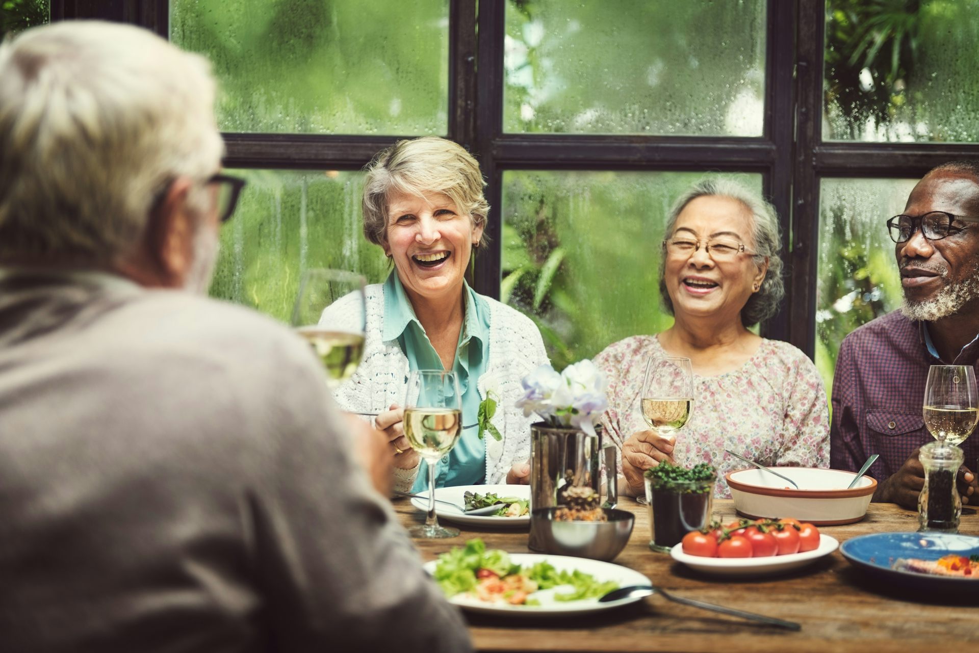 Un grupo de personas con gris sentado en la mesa del comedor.