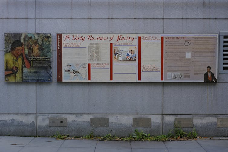 Panels with pictures and text affixed to the exterior of a building