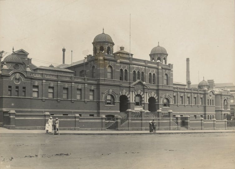 A black and white photo of the front exterior of Melbourne City Baths.