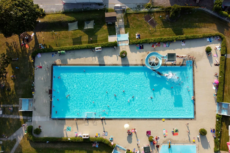 Aerial view of a public pool on a sunny day.