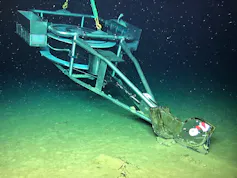 An unmanned submarine pushing a plough along the seabed