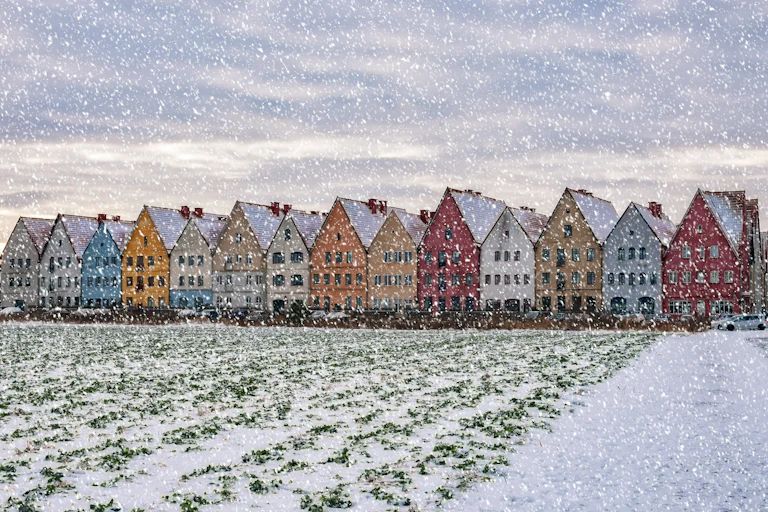 A row of brightly coloured houses in southern Sweden, pictured during a snowstorm.