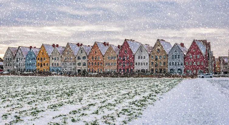 A row of brightly coloured houses in southern Sweden, pictured during a snowstorm.