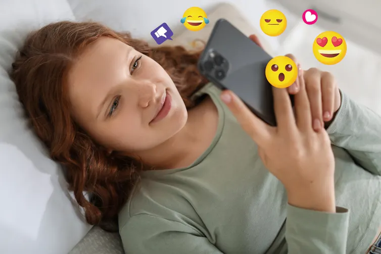 Une adolescente envoie des émojis sur son smartphone