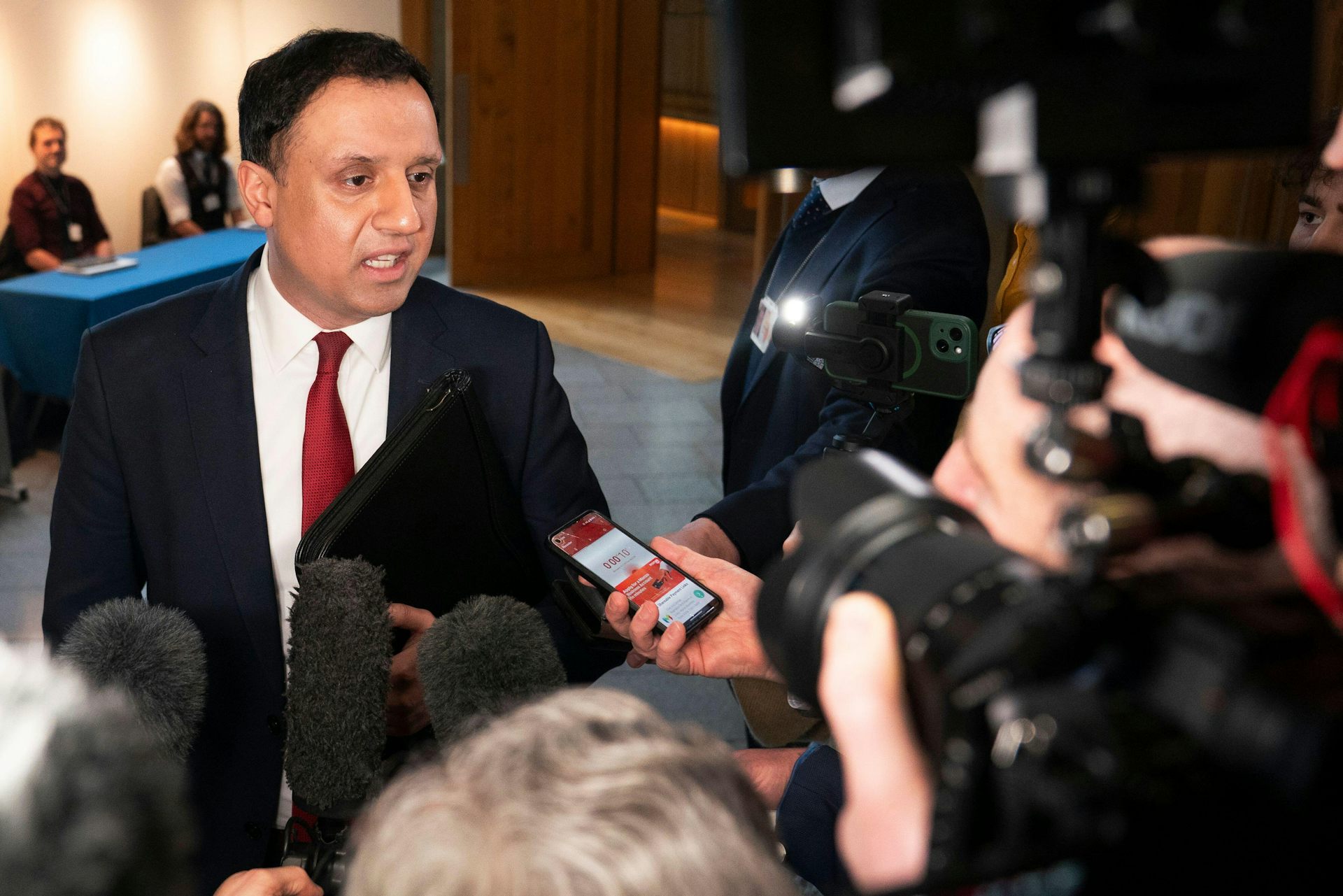 Anas Sarwar talking to reporters. 