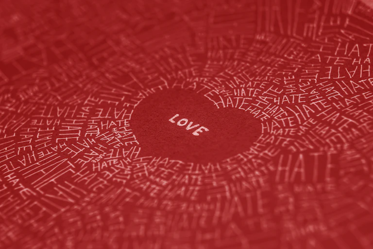 The word 'love' is written in a red heart shape, surrounded by the word 'hate' written many times.