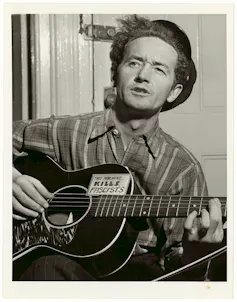 A black-and-white photo of a man playing guitar