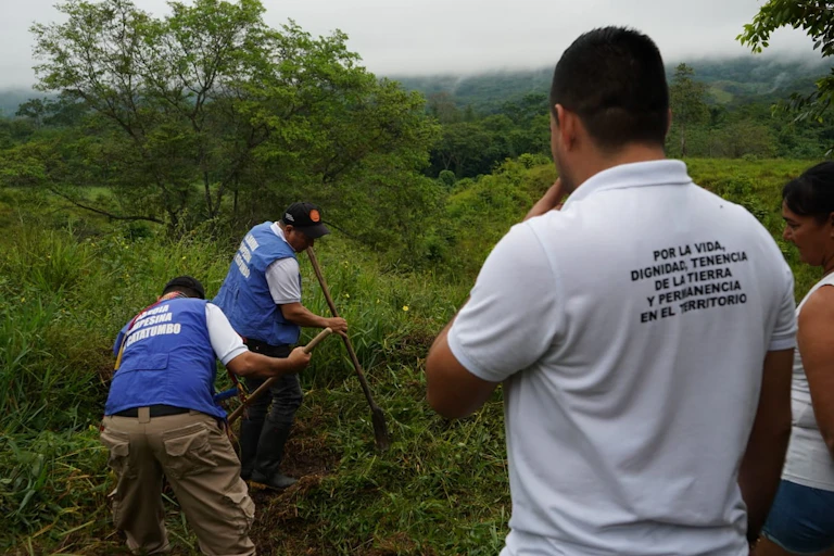 Members of a Colombian association working in a field.